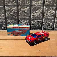 Toy car and original box side by side
