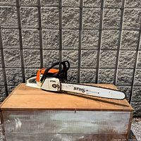 Full view of STIHL 024 AV Super chainsaw on crate
