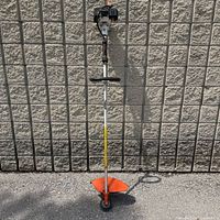 Full view of Stihl FS81 trimmer leaning on wall