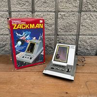 Game unit displayed beside original box