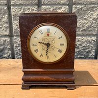 Front view of General Electric mantle clock showing dial and wooden case