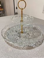 Assembled two-tier tray showing plates and gold handle