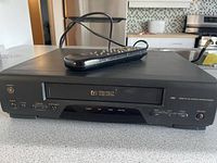 Front view of GE Profect 7 VHS VCR with remote on top