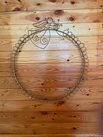 Full view of metal wreath frame hung on wall