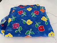 Folded blue floral tablecloth overview