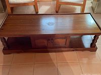 Full view of coffee table top, legs, and shelf