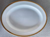 Top view of white oval platter with gold trim