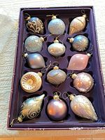 Entire set of 14 glass ornaments in original tray showing variety of shapes and colours
