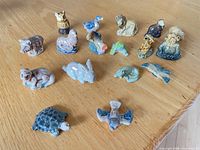 All 18 miniature Wade animal figurines on table