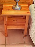 Front view of one nightstand showing top and open shelf