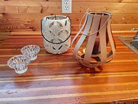 full lot showing two glass holders, ceramic lantern, metal lantern
