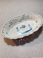 Angled view of oval platter showing interior decoration and edge cut-outs