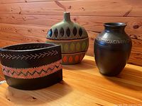 Group shot of three ceramic pieces on wood surface