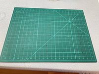 Green cutting mat with grid lines