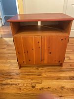 Front view of pine cabinet showing doors and open shelf