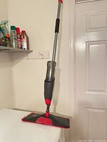 Full view of Rubbermaid Reveal spray mop standing upright
