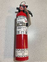 Full view of fire extinguisher with bracket attached