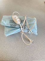 Heating pad folded with controller and cord visible