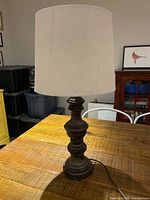 Full view of lamp with shade on tabletop