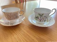 Front view of both teacup and saucer sets showing patterns