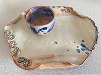 Platter with bowl placed on top showing size relation and glaze tones