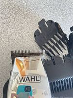 Clipper head with Wahl logo and two guards visible