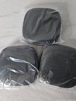 Three Anker speakerphones in plastic wrap
