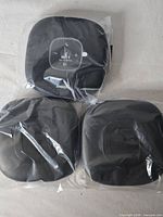 Three Anker speakerphones in plastic wrap