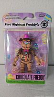 Front view of sealed Chocolate Freddy action figure in package