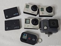 Group shot of four GoPro cameras, two batteries and remote