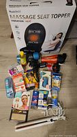 Overview of entire lot showing boxed seat topper and assorted items