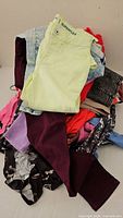 Pile of assorted women’s and girls’ clothing items