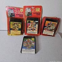 Front view of four sealed 2-XL 8-track tapes