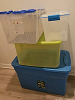 Stack of four plastic bins showing sizes and lids
