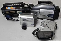Four camcorders grouped: Sony Handycam, Panasonic Palmcorder, Panasonic PV-GS, JVC CyberCam