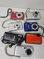 Group of seven cameras showing fronts and colors