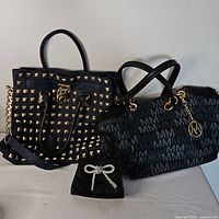 Three purses: studded tote, monogram shoulder bag, small wallet