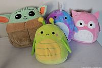 Front view of all four Squishmallows showing design and condition