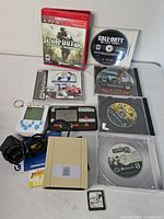 All items laid out showing discs, handheld games, drive and adapter