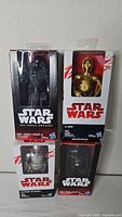All four boxed Star Wars figures stacked two by two
