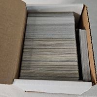 Full cardboard box filled with trading cards