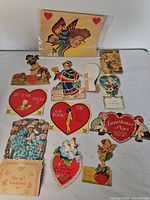Group shot showing all assorted vintage Valentine cards laid out on surface