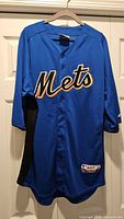 Full front view of Mets Majestic Cool Base jersey on hanger