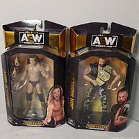 Front view of both AEW Unrivaled action figures in boxes