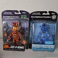 Front view of both sealed action figures in original packaging