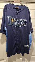 Full front view of the Tampa Bay Rays jersey showing color, logo, and button closure