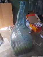 Full view of large twisted hand blown glass bottle