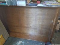 Front of brown veneer bookcase carcass showing finish wear