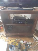 Front view of TV stand with two shelves and casters visible