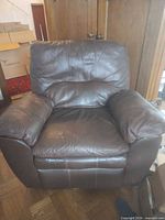 Front view of first brown leather recliner